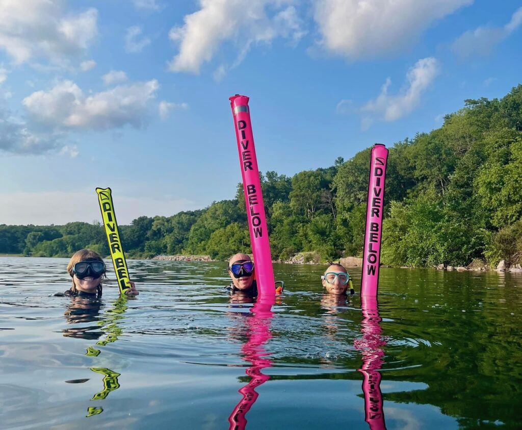 3 divers with 3 dive buoys